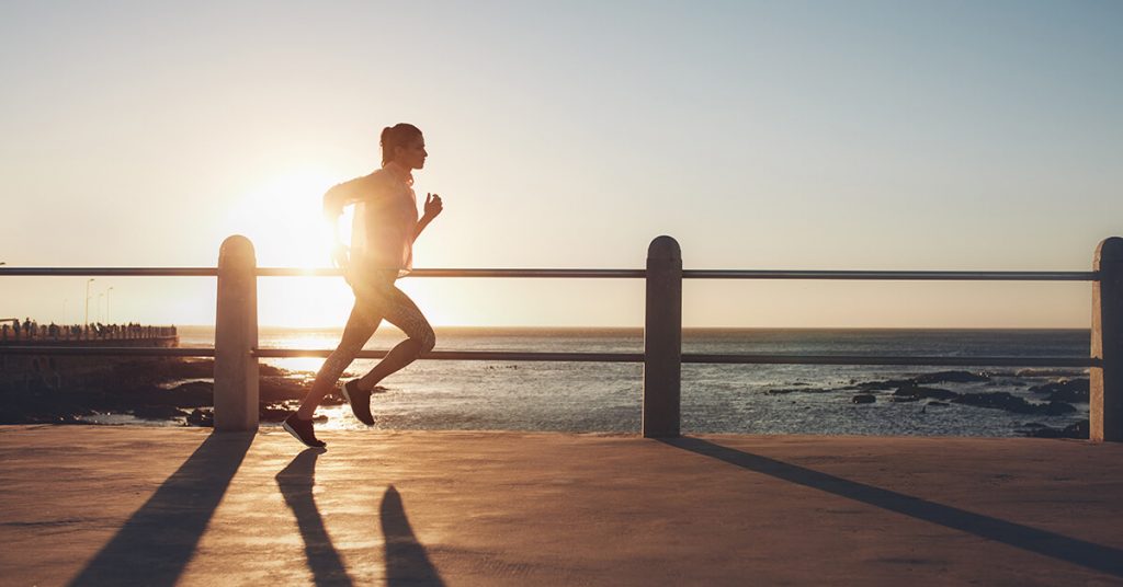 person running next to the ocean