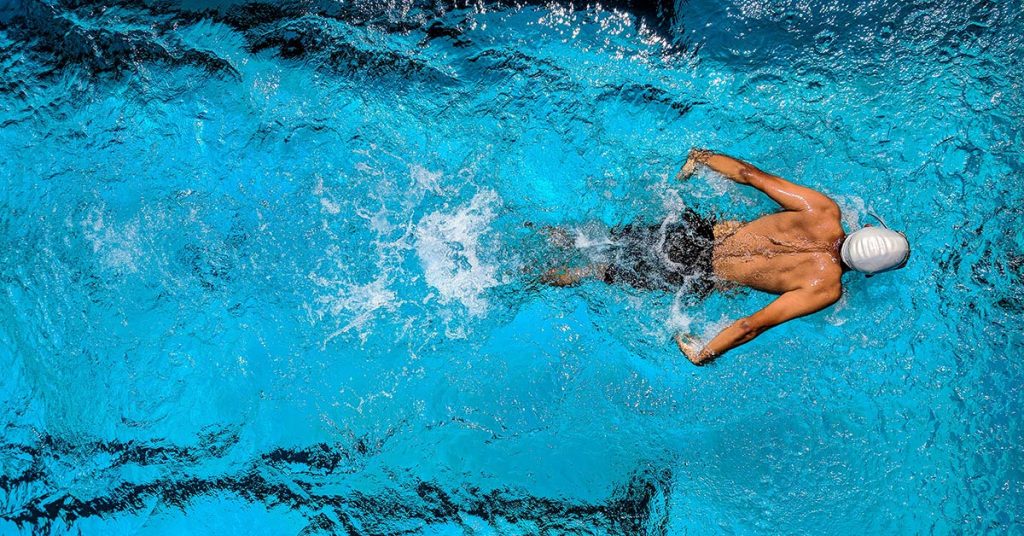 athletes swimming in swimming pool