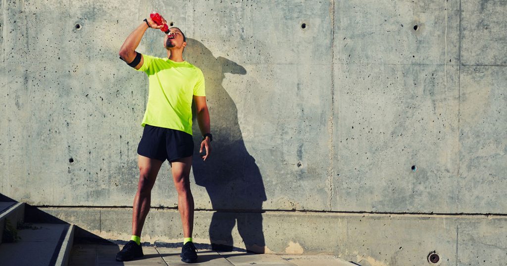 man drinking sports drink for hydration