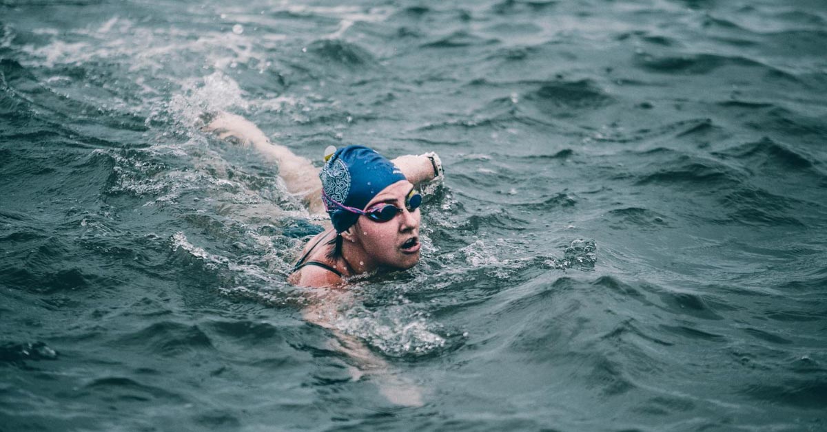 swimmer in cap in open ocean