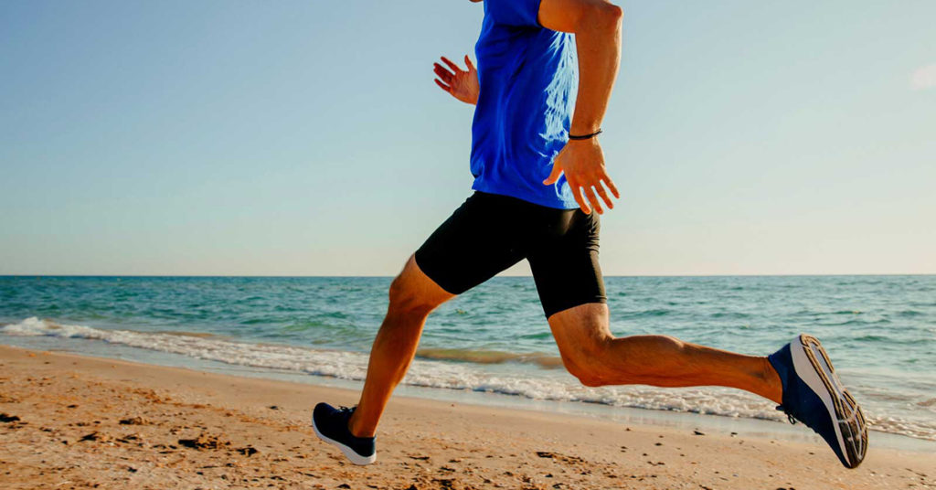 man running along the beach